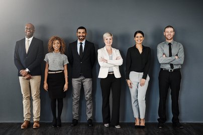 Studio portrait of a group of businesspeople posing against a dark background